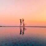 Two people dancing at poolside