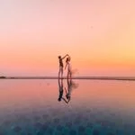 Two people dancing at poolside
